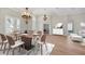 Elegant dining room with a modern chandelier, a dining table set for six, and ample natural light at 12622 Safe Harbour Dr, Cortez, FL 34215