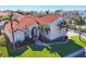 Beautiful single-Gathering home with a red tile roof, lush landscaping, and a well-maintained lawn and exterior columns at 12622 Safe Harbour Dr, Cortez, FL 34215