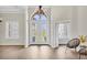 Welcoming foyer with high ceilings, a modern chandelier, and decorative glass double doors, leading to the rest of the home at 12622 Safe Harbour Dr, Cortez, FL 34215