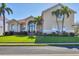 Stunning two-story home with lush landscaping, well-manicured lawn, grand double-door entry, and beautiful arched windows at 12622 Safe Harbour Dr, Cortez, FL 34215
