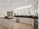 Gourmet kitchen with stainless steel appliances, black countertops, and a center island at 12622 Safe Harbour Dr, Cortez, FL 34215
