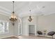 Bright, open living space with luxury vinyl floors, modern chandeliers, and abundant natural light at 12622 Safe Harbour Dr, Cortez, FL 34215
