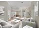 Bright living room with a decorative rug, modern furniture, and an open floor plan leading to the dining area at 12622 Safe Harbour Dr, Cortez, FL 34215