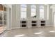 A bright sitting room with custom built-in shelving and three large windows at 12622 Safe Harbour Dr, Cortez, FL 34215