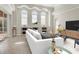 Cozy living room featuring built-in shelving, neutral decor, and sliding glass doors to the outdoor area at 12622 Safe Harbour Dr, Cortez, FL 34215