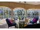 Inviting screened-in lanai with comfortable seating, creating the perfect outdoor living space around the spa at 12622 Safe Harbour Dr, Cortez, FL 34215