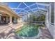 A beautiful screened-in pool area and patio with a pool and jacuzzi at 12622 Safe Harbour Dr, Cortez, FL 34215