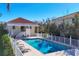 Refreshing community pool with chaise lounges, white fencing, and a covered seating area at 12622 Safe Harbour Dr, Cortez, FL 34215