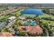 Stunning aerial view of community pool, golf course, and lake surrounded by beautiful homes at 12730 Sorrento Way # 102, Lakewood Ranch, FL 34211