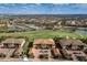 Aerial view of a community with tile roofs, green spaces, a golf course, and multiple buildings at 12730 Sorrento Way # 102, Lakewood Ranch, FL 34211