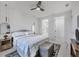 Tastefully designed bedroom with cool color accents, decorative mirror, and access to ensuite bathroom and closet at 1313 Kacerik St, North Port, FL 34288
