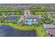 Extensive aerial view featuring community pool, lakes, tennis courts, and clubhouse nestled in a Primary-planned community at 13630 Deep Blue Pl, Bradenton, FL 34211