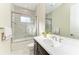 Bathroom featuring marble-tiled shower, sleek vanity and a large mirror at 13630 Deep Blue Pl, Bradenton, FL 34211