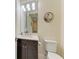 Elegant powder room with a modern vanity, designer mirror, and updated fixtures at 13630 Deep Blue Pl, Bradenton, FL 34211