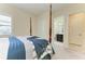 Bedroom featuring a four-poster bed and an ensuite bathroom with a tiled shower at 13630 Deep Blue Pl, Bradenton, FL 34211