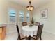 Bright dining area features a round table, four chairs, and a stylish Tiffany-style chandelier at 13630 Deep Blue Pl, Bradenton, FL 34211