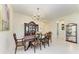 Classic formal dining room with an elegant chandelier, hardwood table and chairs, and a display cabinet at 13630 Deep Blue Pl, Bradenton, FL 34211