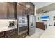 Stainless steel appliances and dark cabinetry in the modern kitchen at 13630 Deep Blue Pl, Bradenton, FL 34211