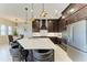 Spacious kitchen featuring dark cabinetry, a large island, and stainless steel appliances at 13630 Deep Blue Pl, Bradenton, FL 34211