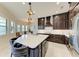 An open kitchen featuring a large island and modern appliances adjacent to a breakfast nook at 13630 Deep Blue Pl, Bradenton, FL 34211