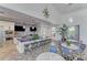 Spacious clubhouse kitchen with modern appliances, island seating, and stylish blue and white mosaic backsplash at 13630 Deep Blue Pl, Bradenton, FL 34211