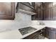 Close-up of the kitchen countertop with white backsplash and gas stovetop at 13630 Deep Blue Pl, Bradenton, FL 34211