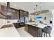 View of the kitchen island with sink and chairs, overlooking the living room at 13630 Deep Blue Pl, Bradenton, FL 34211