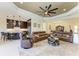 Spacious living room features elegant tray ceilings, neutral paint, and flows into the kitchen and dining area at 13630 Deep Blue Pl, Bradenton, FL 34211