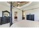 A stately bedroom with decorative furniture, tray ceiling, and a ceiling fan at 13630 Deep Blue Pl, Bradenton, FL 34211