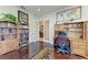 Bright office with built-in shelving, wooden desk, and a view to another room through french doors at 13630 Deep Blue Pl, Bradenton, FL 34211