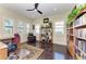 A spacious office with a dark wooden desk, bookshelves, and a comfortable armchair at 13630 Deep Blue Pl, Bradenton, FL 34211