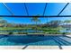 Stunning pool overlooks a serene pond and lush landscaping, providing a private backyard oasis at 13630 Deep Blue Pl, Bradenton, FL 34211