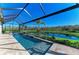 Screened-in pool features a gorgeous backyard view of the pond and surrounding greenery at 13630 Deep Blue Pl, Bradenton, FL 34211