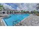 Large community pool with clear blue water, lounge chairs, and manicured landscaping at 13630 Deep Blue Pl, Bradenton, FL 34211