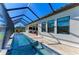 A long screened-in pool runs along the side of the home with ample room for seating at 13630 Deep Blue Pl, Bradenton, FL 34211