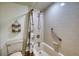 Cozy bathroom features a tiled shower and tub with a decorative curtain at 1760 Gulf Blvd # 603, Englewood, FL 34223