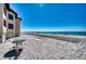 Stunning beach featuring a building and chairs with easy access to water at 1760 Gulf Blvd # 603, Englewood, FL 34223