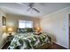 Bright bedroom features tropical bedding, ceiling fan and plush carpet for comfort at 1760 Gulf Blvd # 603, Englewood, FL 34223
