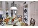 Dining room with a glass table and in unit laundry at 1760 Gulf Blvd # 603, Englewood, FL 34223