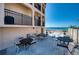 Beachside patio with ocean views and tables with seating for outdoor relaxation at 1760 Gulf Blvd # 603, Englewood, FL 34223