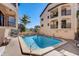 Community pool with lounge chairs in a tropical outdoor area at 1760 Gulf Blvd # 603, Englewood, FL 34223