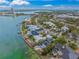 Aerial view of waterfront property with pool, dock, tropical foliage and beach access at 204 N Washington Dr, Sarasota, FL 34236