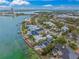 Aerial view of waterfront property with pool, dock, tropical foliage and beach access at 204 N Washington Dr, Sarasota, FL 34236