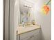 Bathroom featuring a light counter, vanity and a large mirror, with bright flowers painted on the walls at 204 N Washington Dr, Sarasota, FL 34236