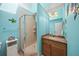 Bright bathroom with a tile walk-in shower, vanity, and beachy decorations create a serene space at 204 N Washington Dr, Sarasota, FL 34236