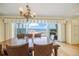 Dining room featuring a wooden table, wicker chairs, and an elegant chandelier with ocean views at 204 N Washington Dr, Sarasota, FL 34236