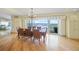 Elegant dining room with a chandelier and sliding glass doors leading to a pool and waterfront view at 204 N Washington Dr, Sarasota, FL 34236