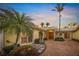 Inviting home exterior with lush landscaping, palm trees, and a brick walkway leading to a double door entrance at 204 N Washington Dr, Sarasota, FL 34236