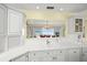Bright kitchen features white cabinets and a pass-through offering stunning views of the ocean at 204 N Washington Dr, Sarasota, FL 34236