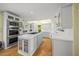 Bright, airy kitchen featuring white cabinetry, a center island, and modern appliances at 204 N Washington Dr, Sarasota, FL 34236